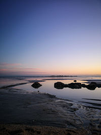 Scenic view of sea against clear sky during sunset