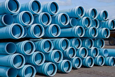 Stack of pipes against blue sky