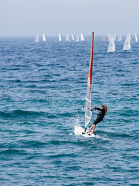 Woman windsurfing on sea
