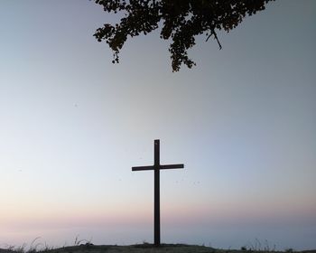 Low angle view of silhouette cross against sky during sunset