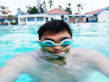 Young man swimming in pool