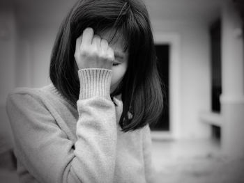 Portrait of beautiful woman standing at home