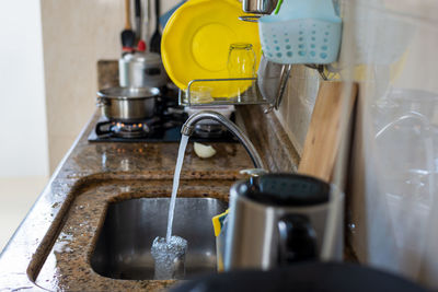 Open sink tap dripping water. take care of the environment. waste of water.