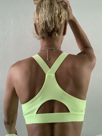 Rear view of woman standing against wall