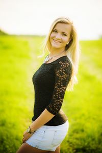 Portrait of young woman standing on ground