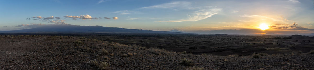 Scenic view of field against sky during sunset