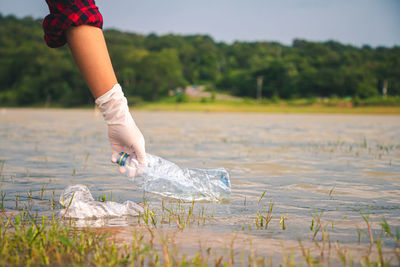 Midsection of person in lake