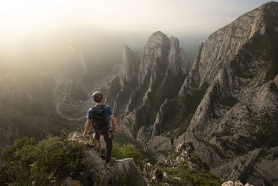 One man standing on a cliff on his way to nido de aguiluchos huasteca