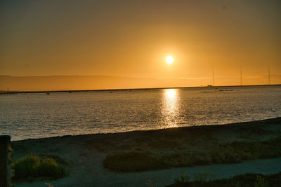 Scenic view of sea against romantic sky at sunset