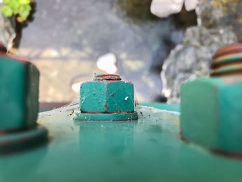 Close-up of rusty metal container in water