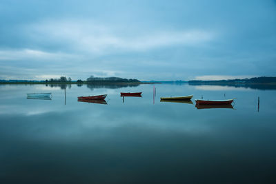Rowboats on still waters at norsminde inlet, denmark