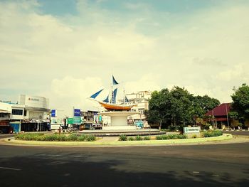 Road by building against sky