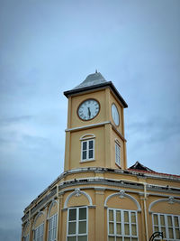 Low angle view of clock tower against sky