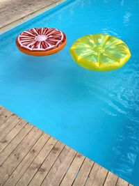High angle view of fruits on table at swimming pool