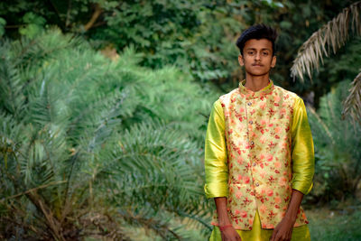 Portrait of man standing against plants