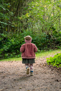 A little child is running in the forest