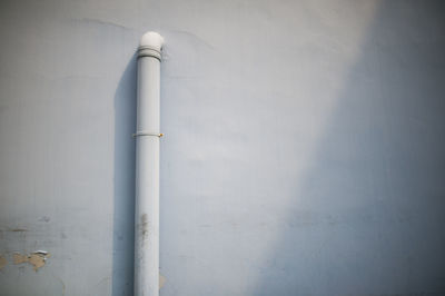 Low angle view of pipe on wall