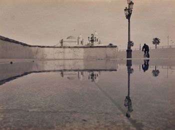 Water spraying against sky