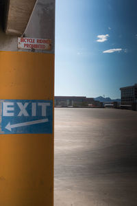 Information sign against sky