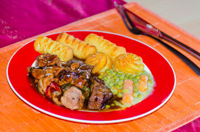 High angle view of food in red plate on table