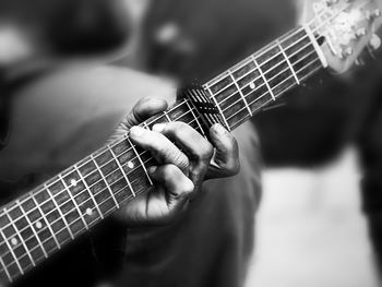 Cropped man playing guitar