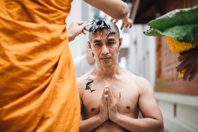 Man trimming hair through razor