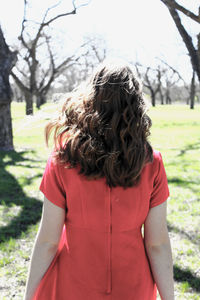 Woman standing on grassy field in park