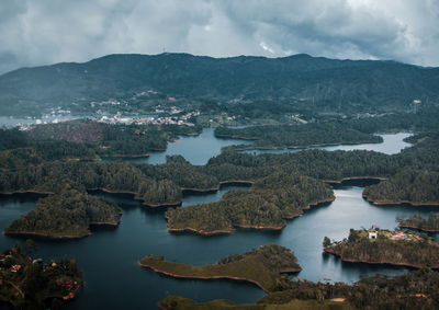 Scenic view of lake and mountains against sky