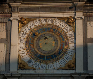 Low angle view of clock tower against building