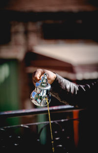 Cropped image of hand pouring tea from teapot