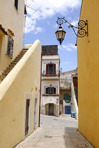 Street amidst buildings against sky