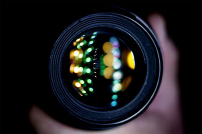 Close-up of hand holding illuminated lighting equipment