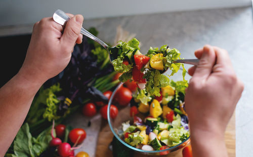 Cropped hand of woman holding food