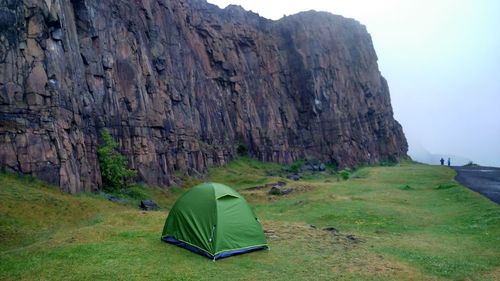 Scenic view of tent on mountain against rock formation