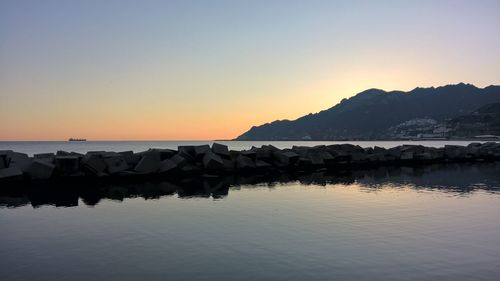 Scenic view of sea against clear sky during sunset