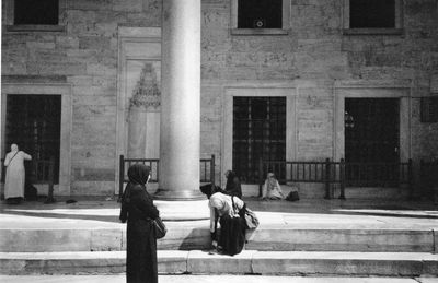 People sitting outside building