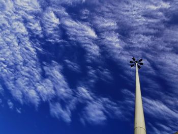 Low angle view of floodlight against blue sky