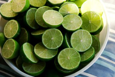 Lime background with sun light from outside. close up shot of limes. selective focus of sliced
