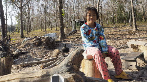 Portrait of girl sitting on land