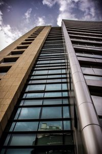 Low angle view of building against cloudy sky