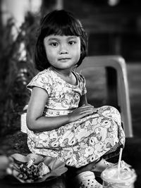 Portrait of girl sitting on the street