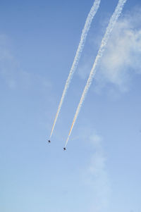 Low angle view of airshow against sky