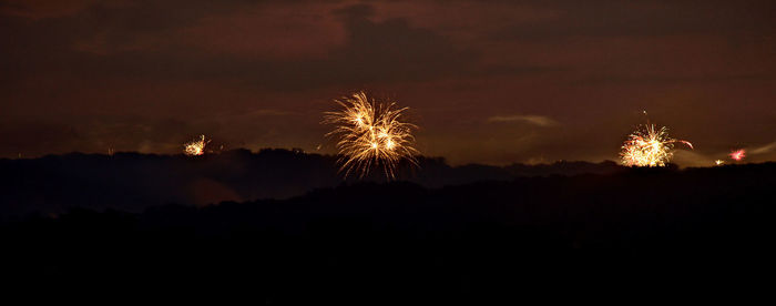 Low angle view of firework display at night