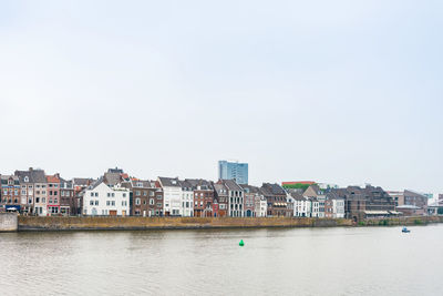 Buildings in city against clear sky