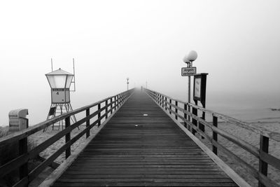 Pier amidst sea against sky during foggy weather