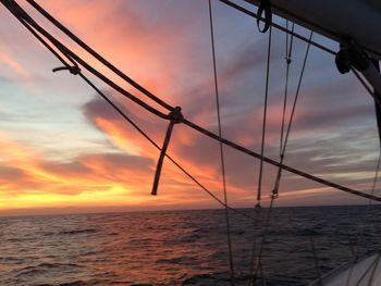 Silhouette sailboat on sea against sky during sunset
