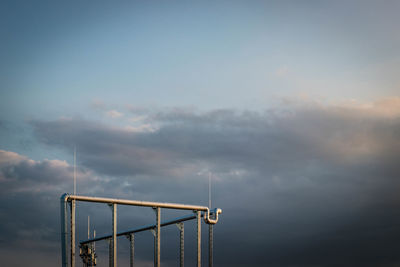 Metallic structure against sky during sunset