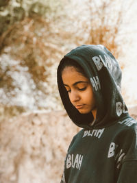 Portrait of young woman standing outdoors