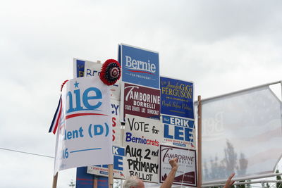 Low angle view of information sign against sky