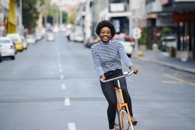 Portrait of man riding bicycle on city street